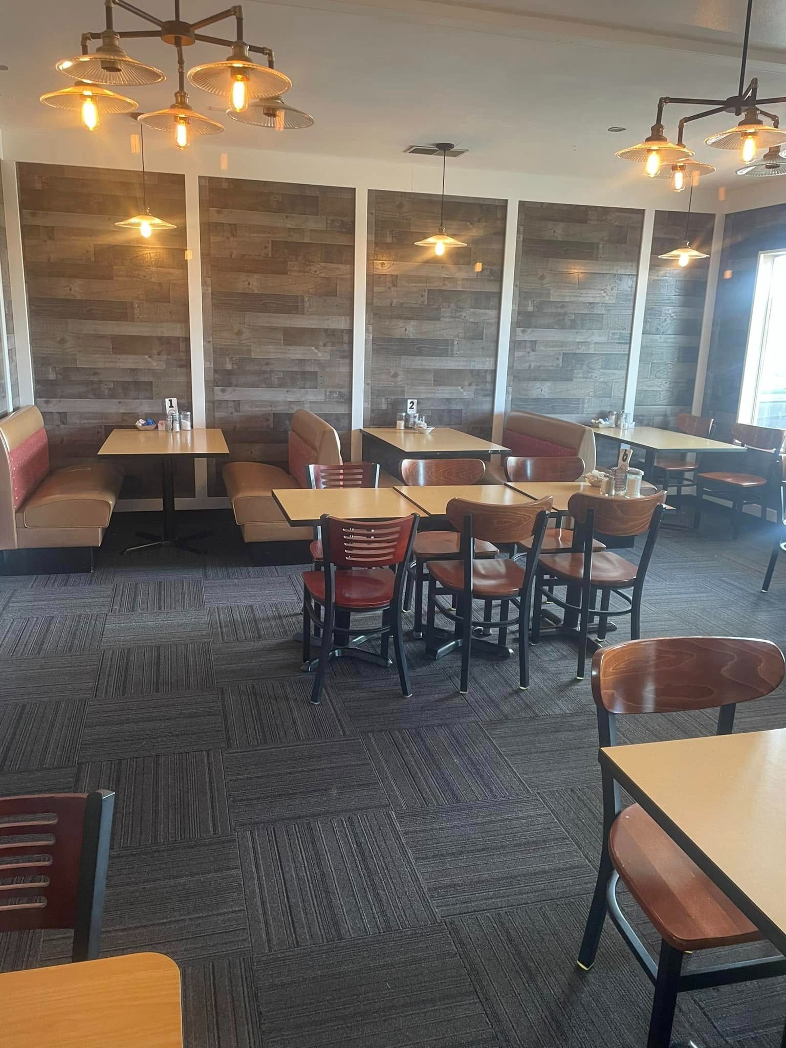 The dining room at Lina's Cafe, with booths, wood-panelled walls and pendant lighting