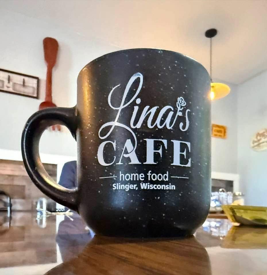 A Lina's Cafe coffee mug reading Home Food, Slinger Wisconsin